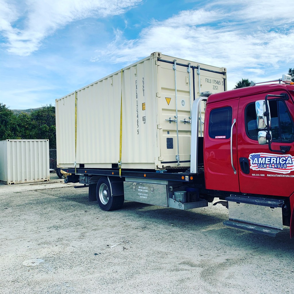 America Tow & Auto transporting a shipping container