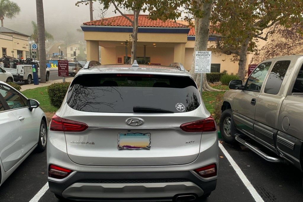 An illegally parked car getting towed off private property in downtown Ventura, CA
