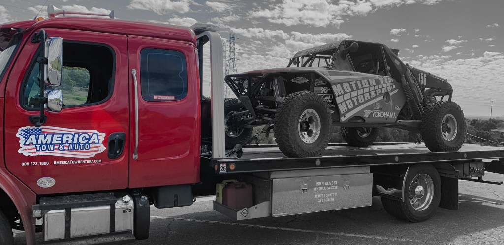 America Tow & Auto towing a custom race car to its destination
